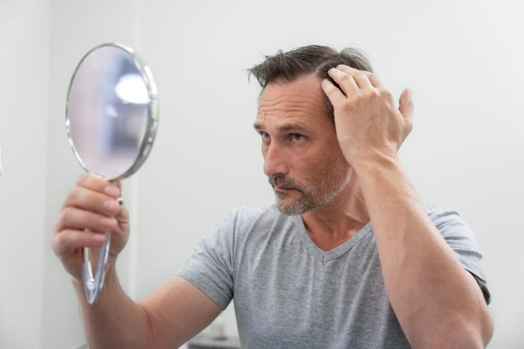 man getting hair loss treatment